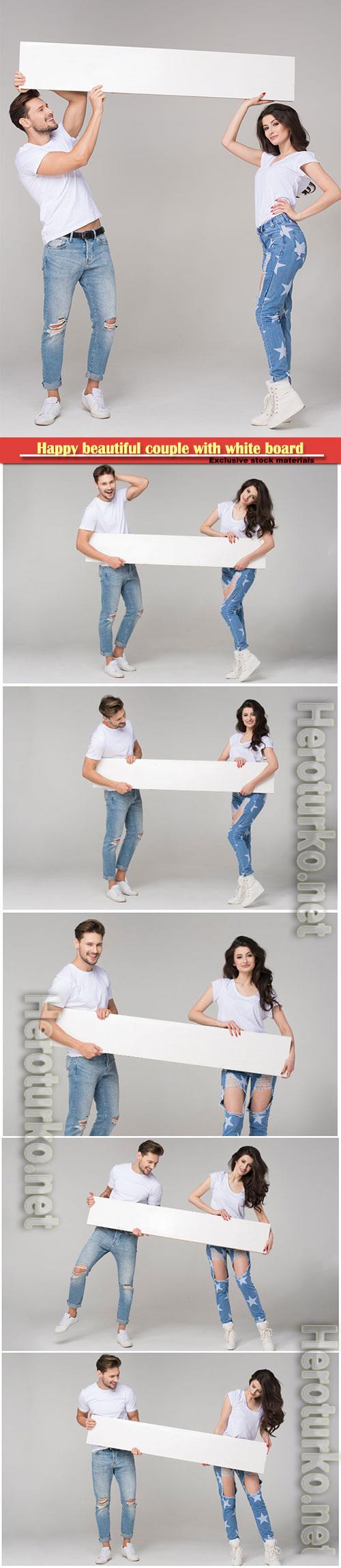 Young couple in jeans hold a white poster Young couple in jeans hold a white poster