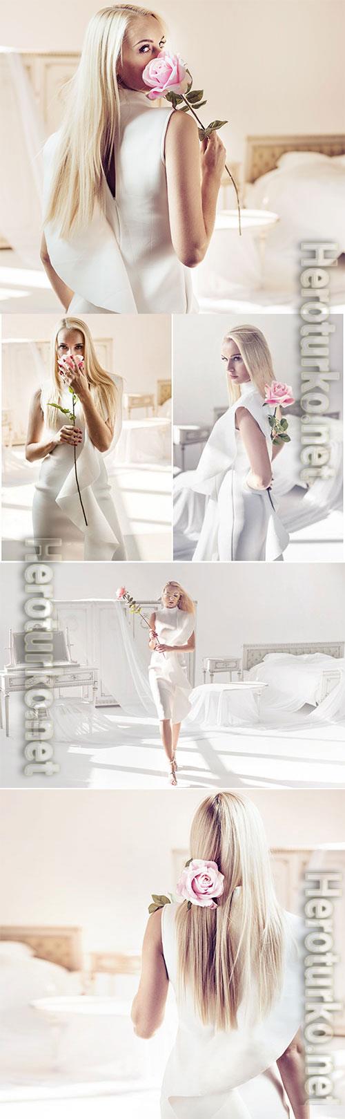 Beautiful girl with pink rose in her hands stock photo Beautiful girl with pink rose in her hands stock photo