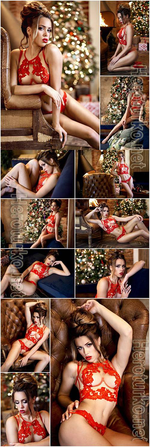 Girl in red lingerie on the background of a christmas tree stock photo Girl in red lingerie on the background of a christmas tree stock photo